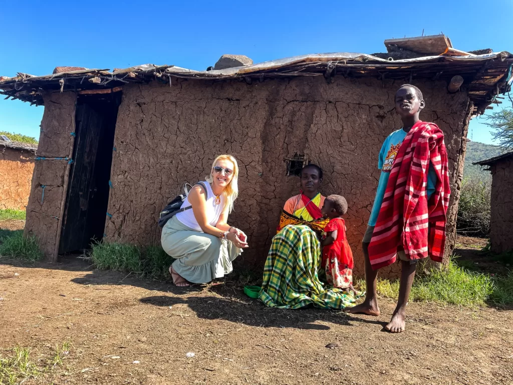 maasai women with her children in front of a house